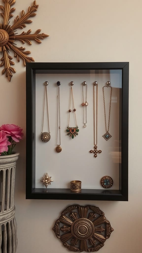 A shadow box display featuring various necklaces and rings in a black frame.